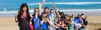 U N E students posing on the beach